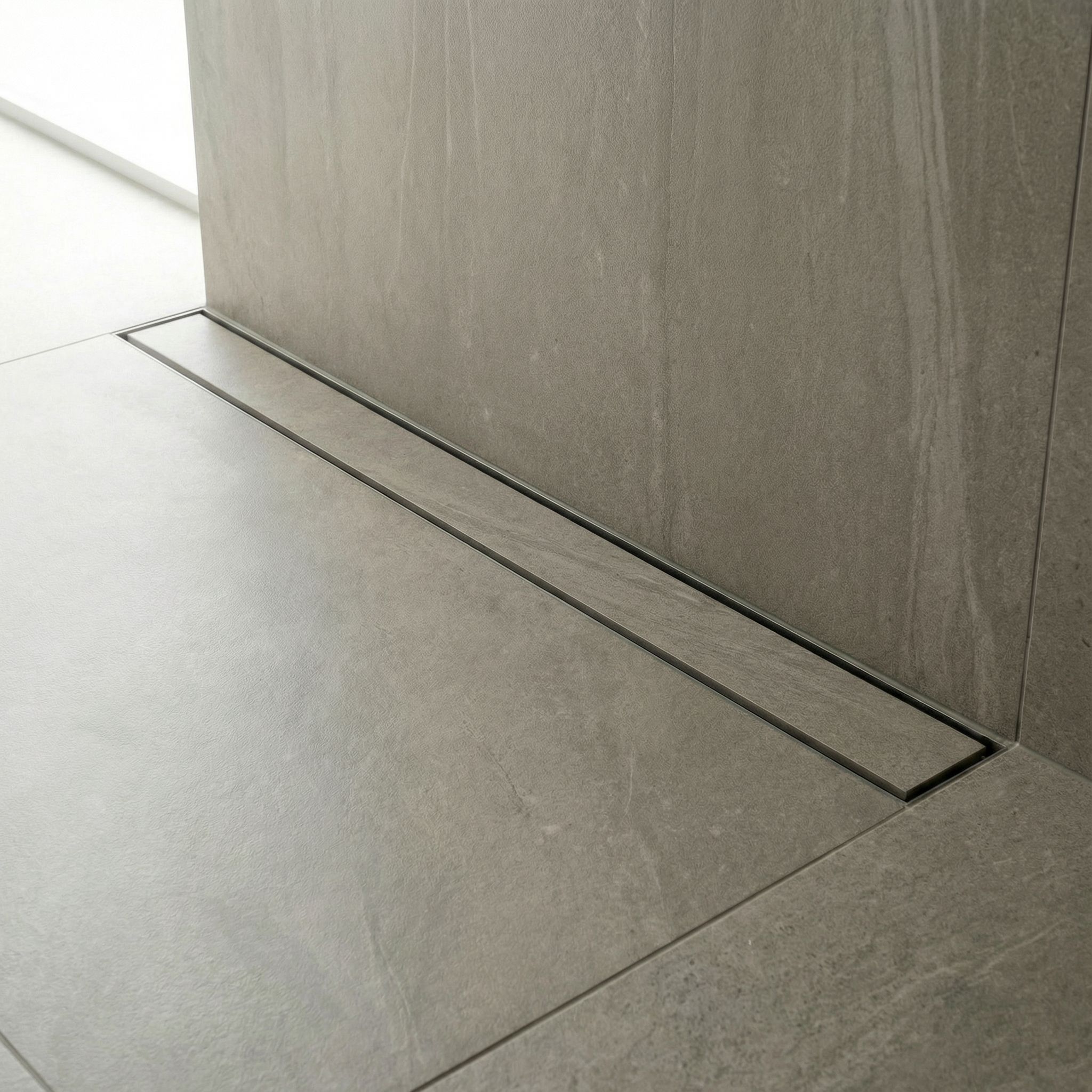 Linear stainless steel floor drain with powder-coated frame and tile-in cover, laser-welded structure for precise alignment