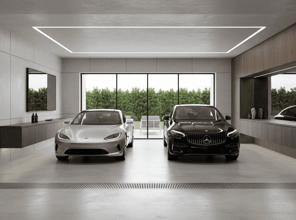 Stainless steel outdoor linear floor drain integrated into a premium two-car garage, supporting vehicle wash drainage, rainwater control, and heavy-duty floor drainage requirements