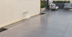 Outdoor linear drainage channel installed along exterior wall, stainless steel grating with concealed drainage design for architectural landscape applications