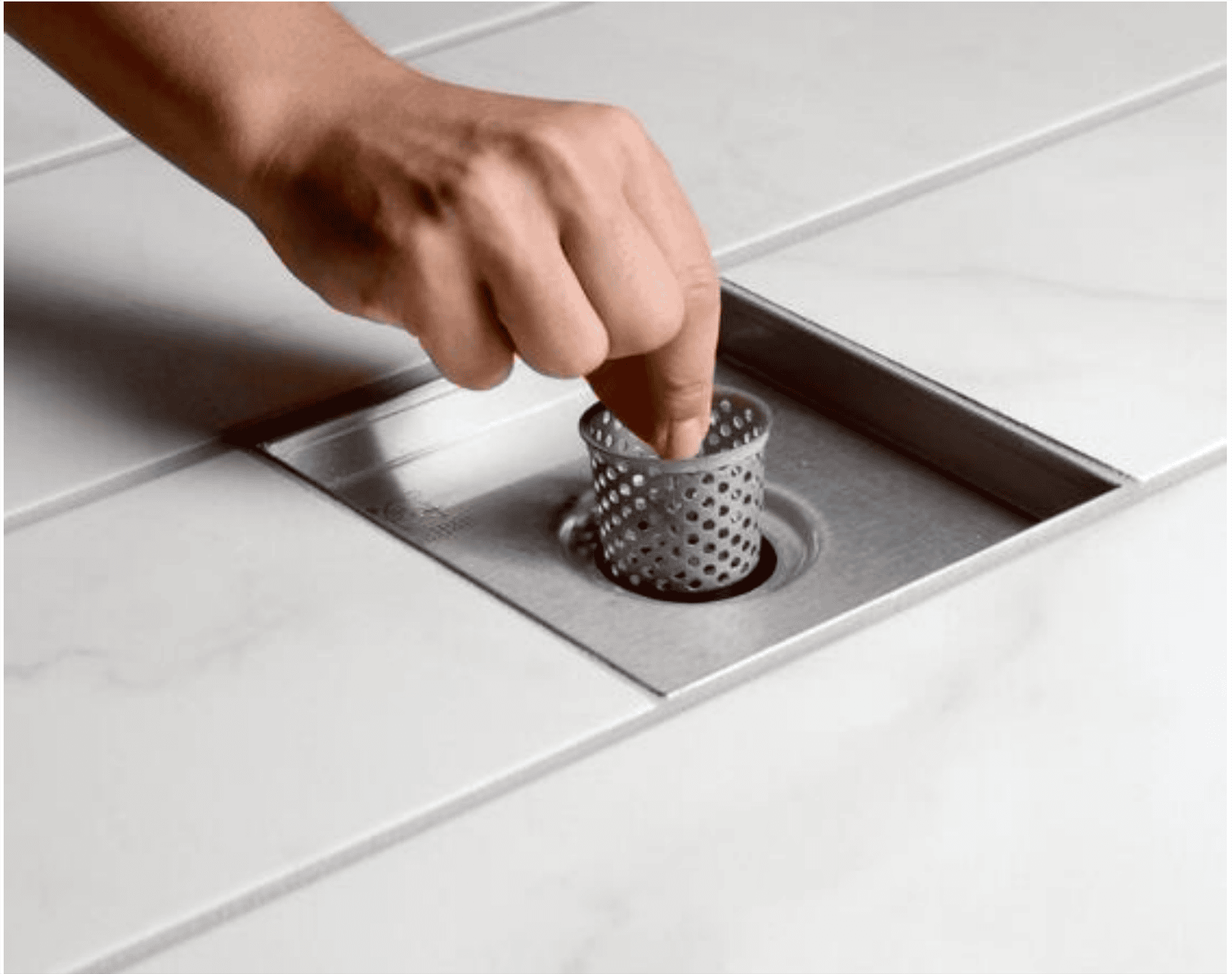 Floor drain with a detachable perforated strainer basket, designed to collect hair and debris for easy cleaning and maintenance.