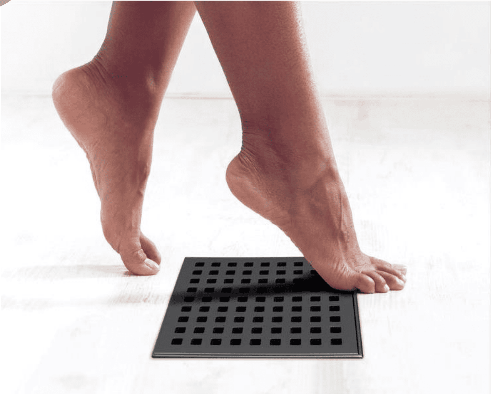 Square stainless steel floor drain with brushed surface, showing fine wire-drawing finish and smooth texture for a comfortable touch underfoot.